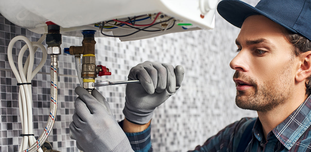 Plumber worker repairing boiler system